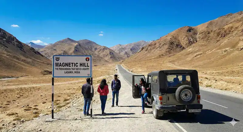 Car moving uphill on Magnetic Hill road in Ladakh