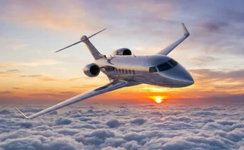 Luxury private jets flying through clouds during sunset